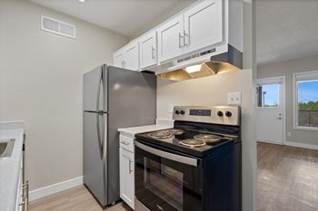 Kitchen with stainless steel appliances and a refrigerator at Elevation Apartments, Tucson, AZ